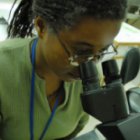 Researcher and microscope